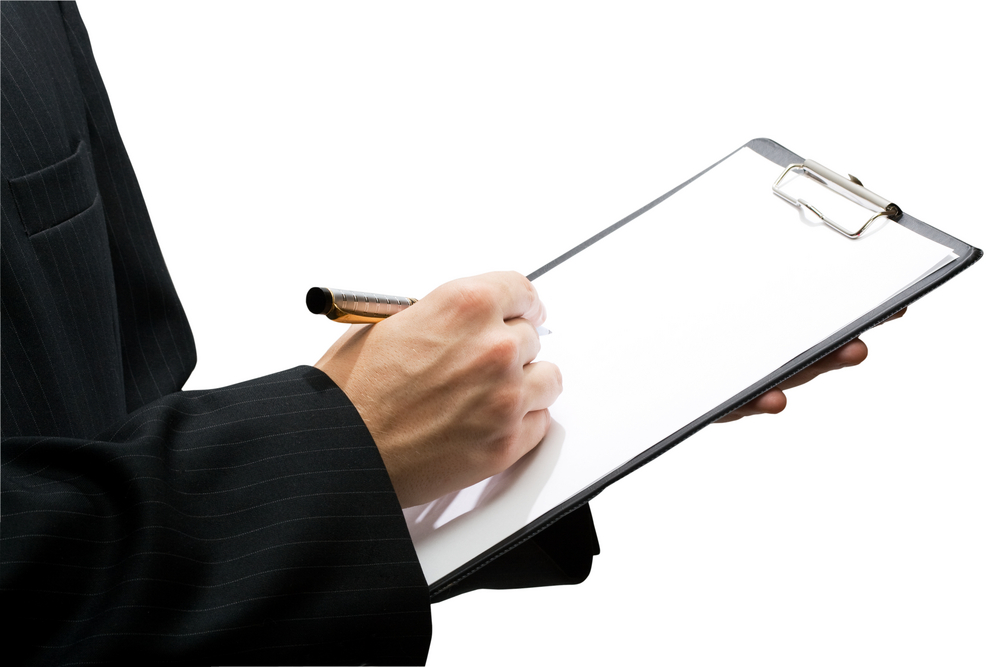 Man holding clipboard and pen